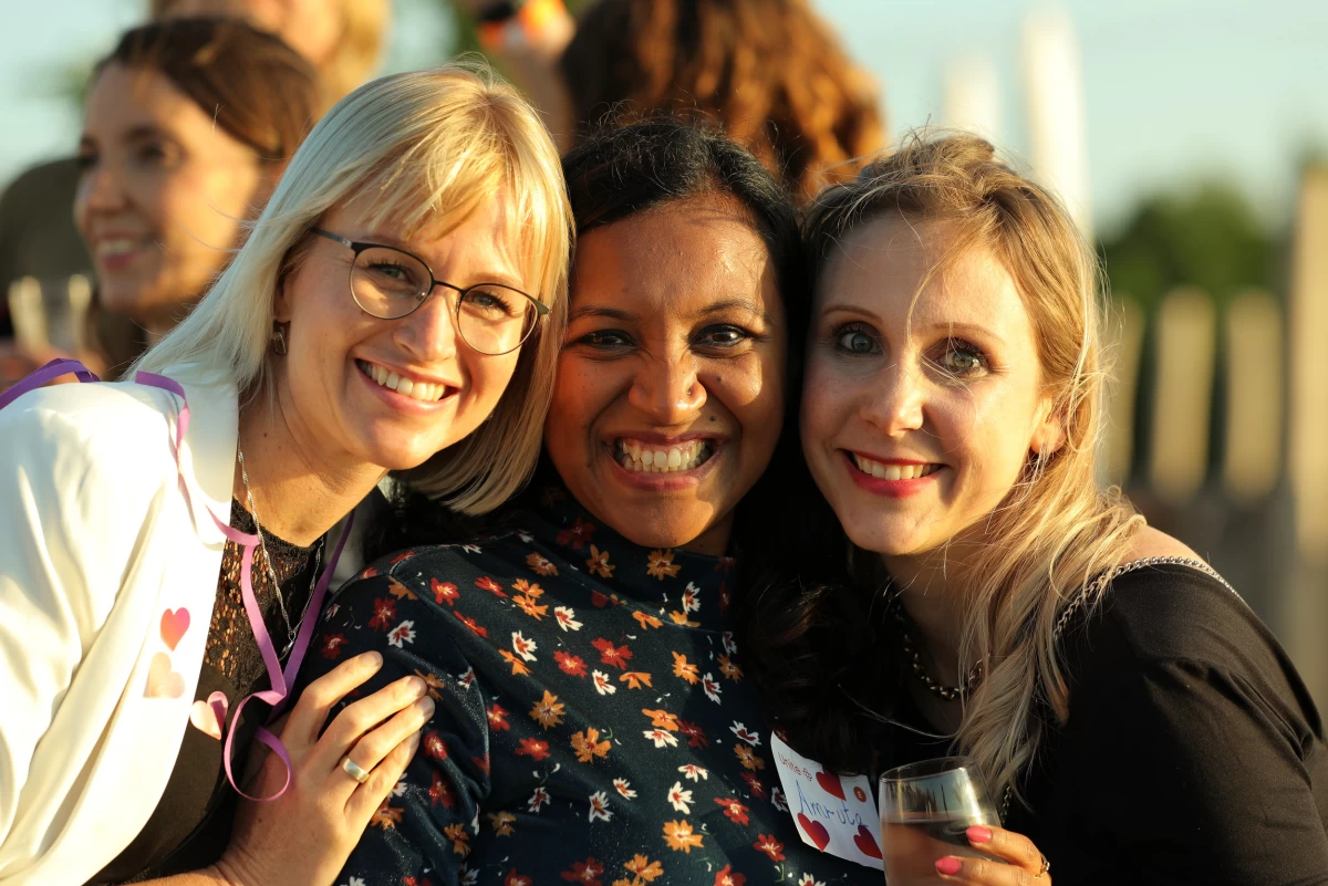 Three female Unitees smiling at the photographer