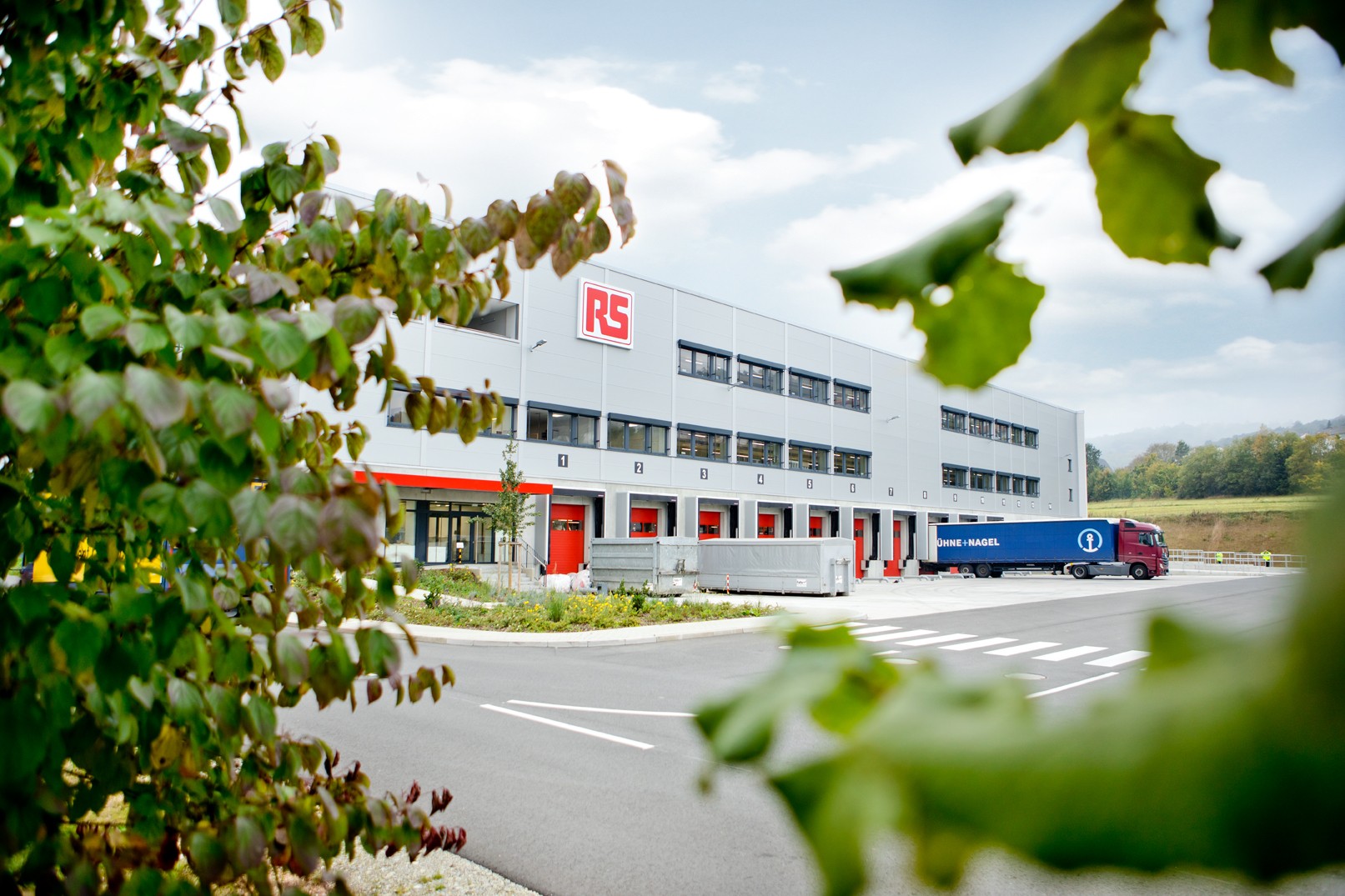 RS company picture showing the RS warehouse in Bad Hersfeld, Germany. A truck stands in front of one of the many loading docks.