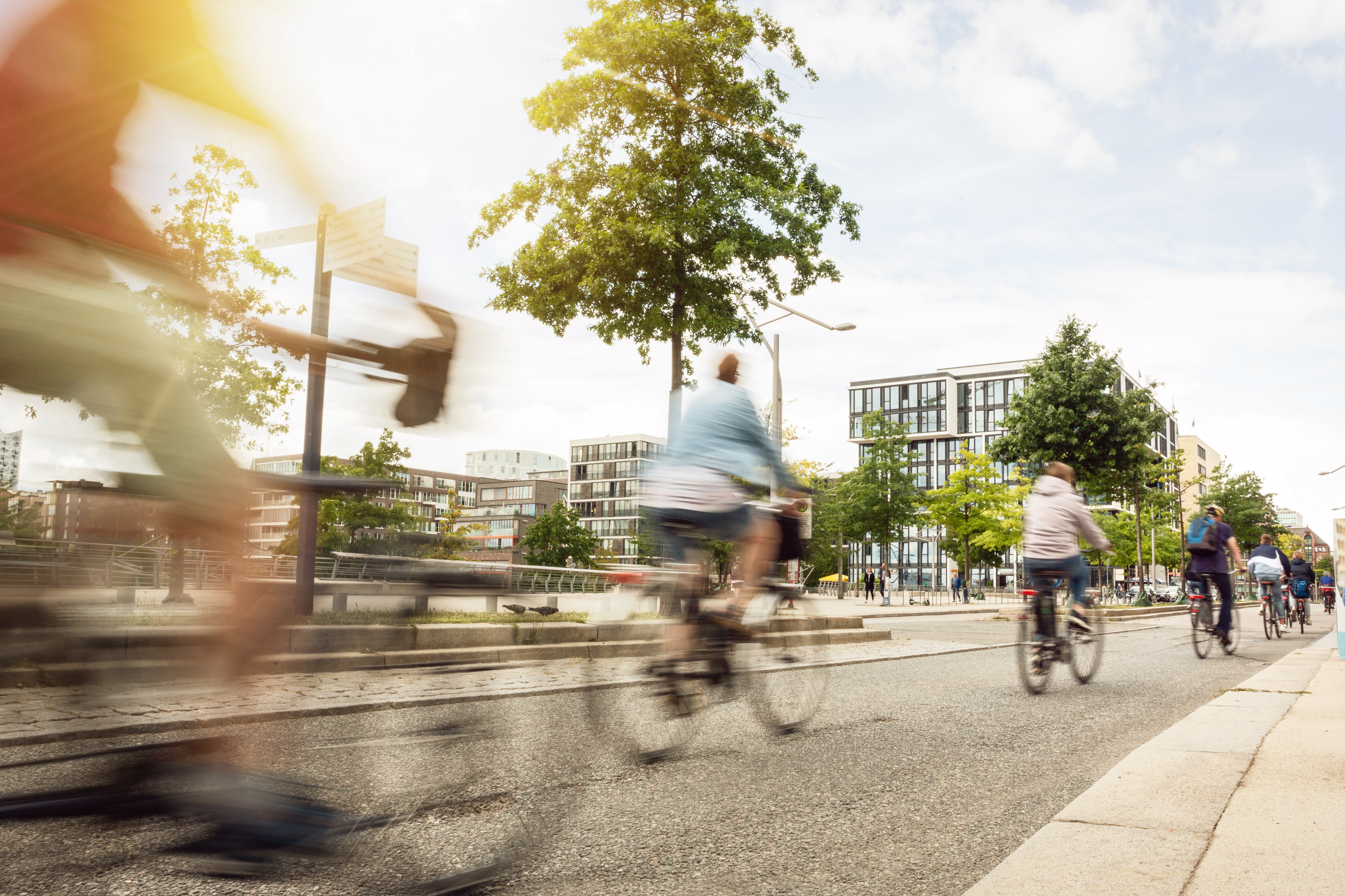 People cycling through an urban landscape