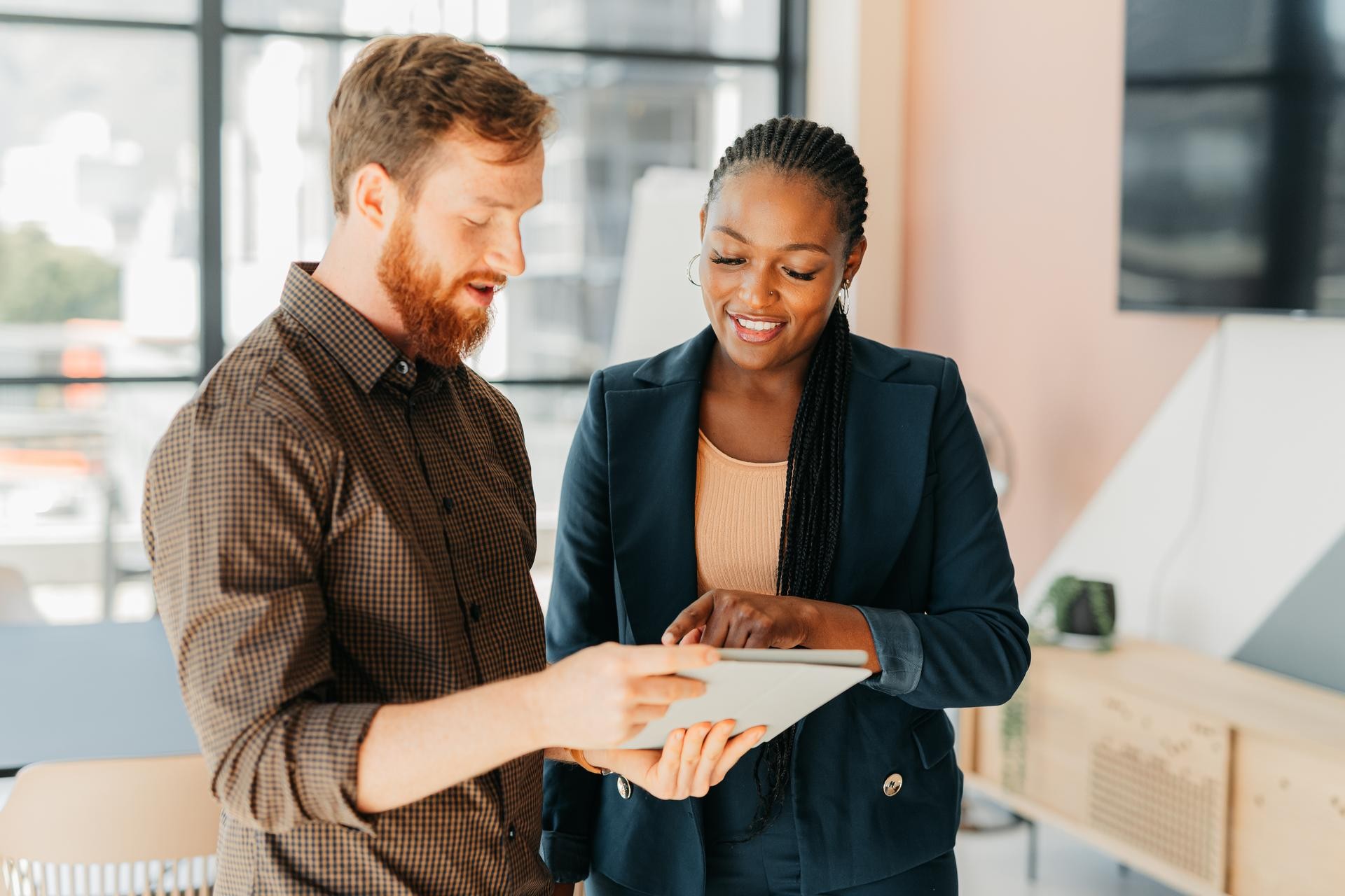 Two procurement professional looking at TCO data