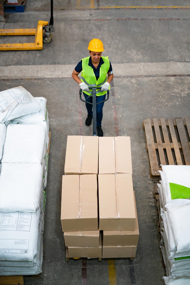 A logistics employee transports parcels