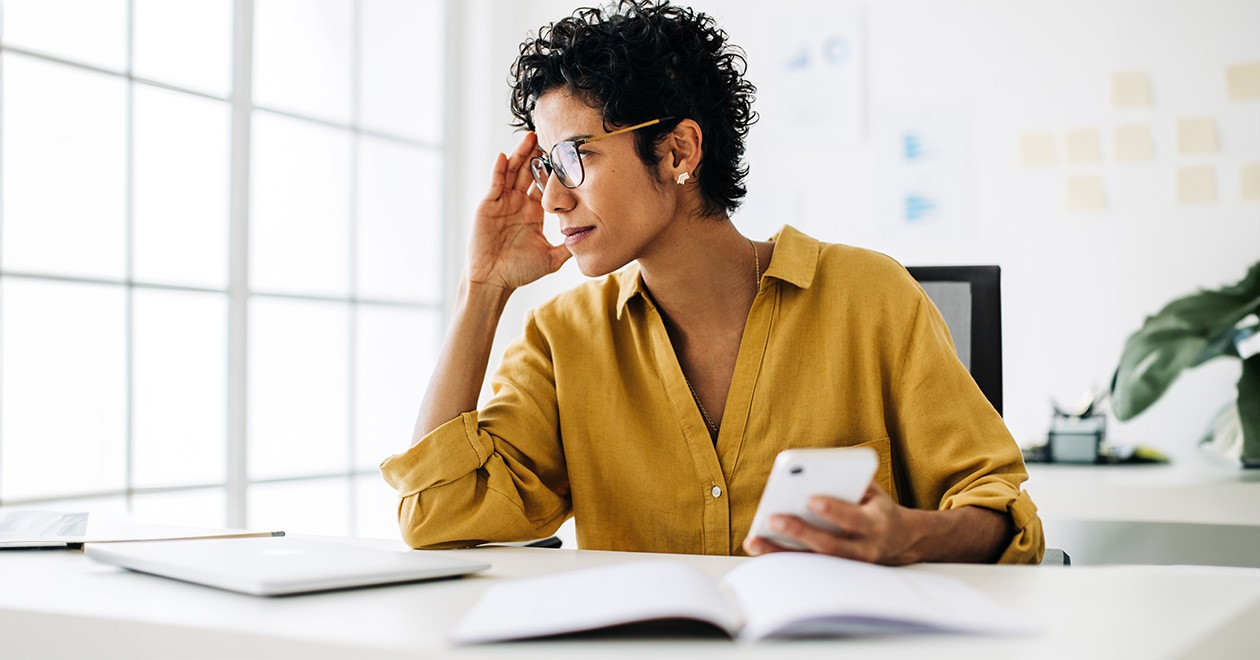 Procurement professional sitting at a desk thinking about a challenge