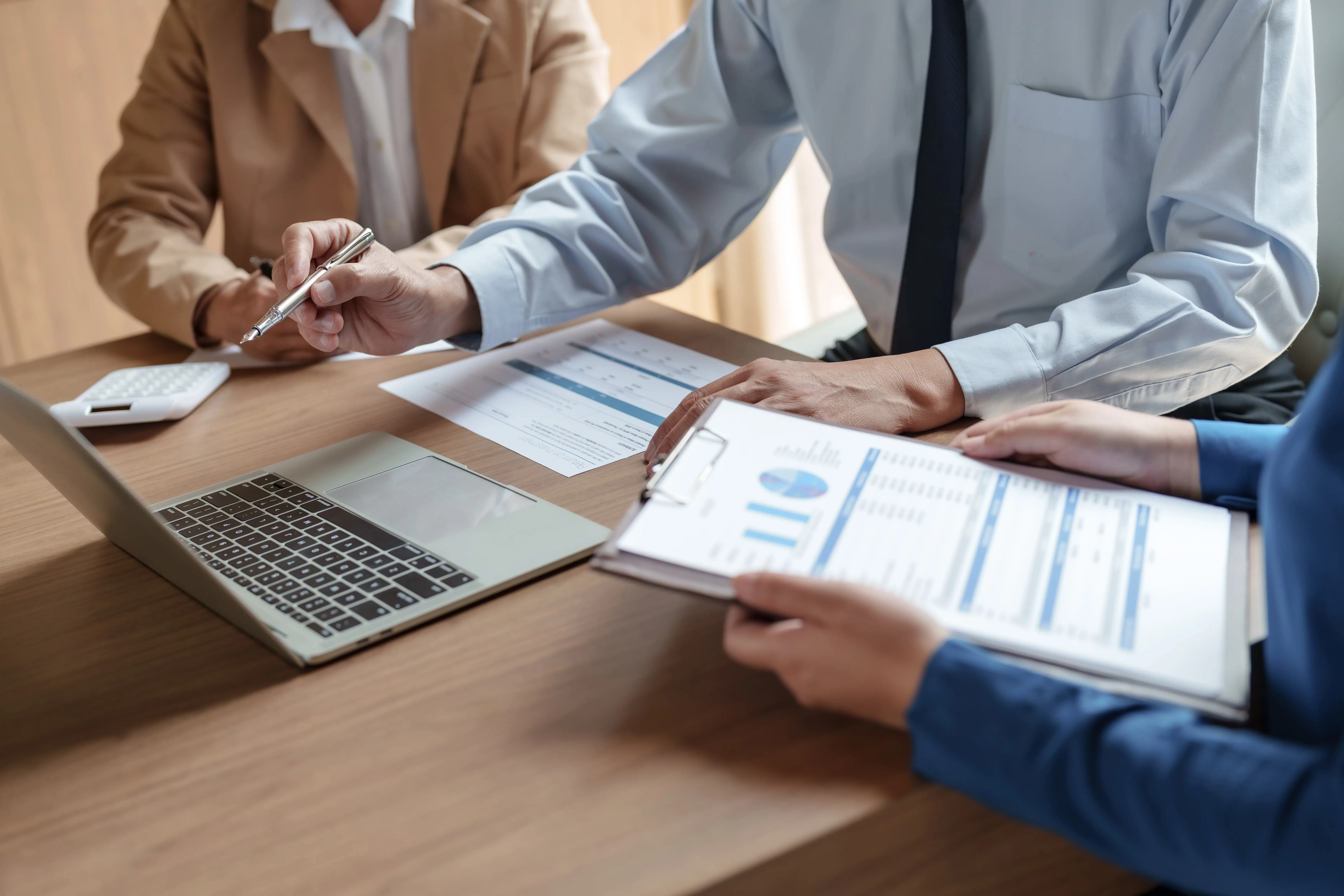 Two people in a business enviroment negotiating a contract.