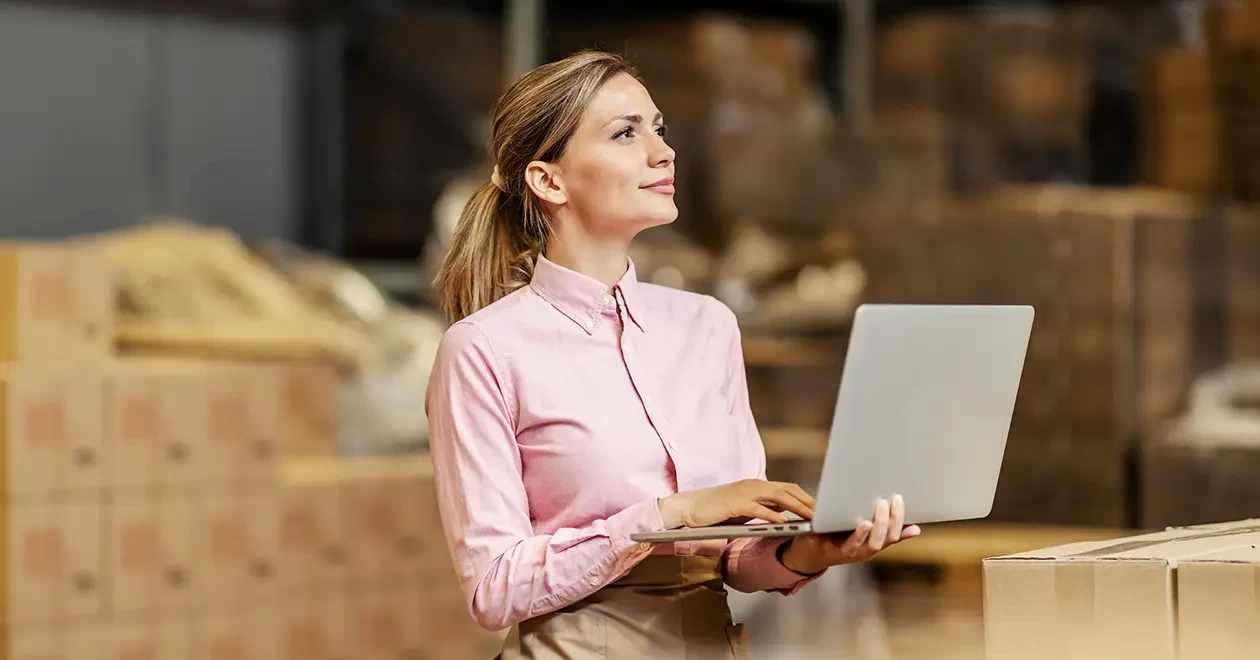 A warehouse manager checks stock