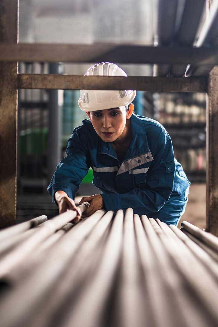 A warehouse employee inspects hardware  