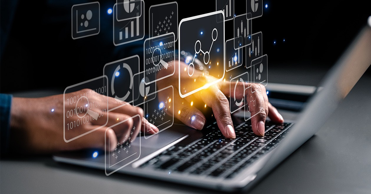 Procurement professional typing in procurement data into a laptop