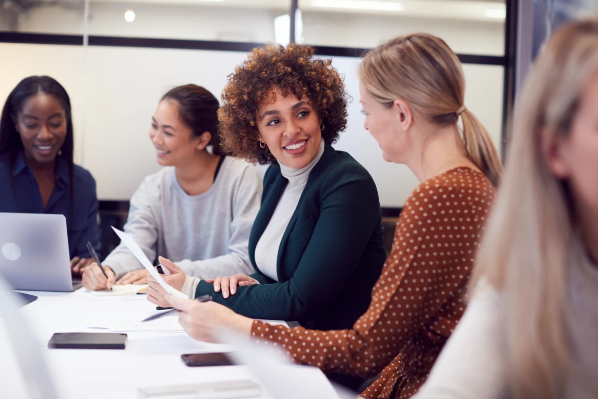 Procurement professionals engaged in a conversation around a table